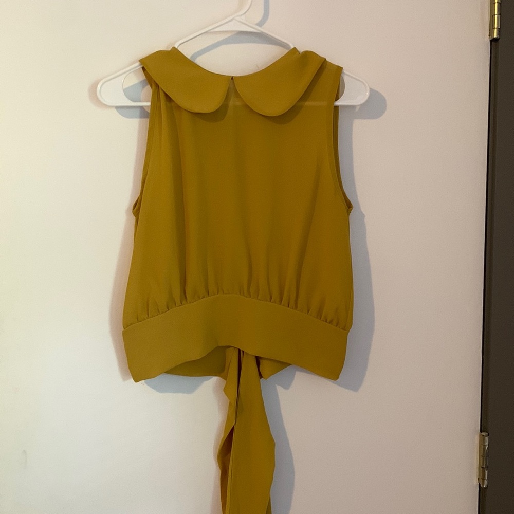 Cute yellow top with tie in the back.